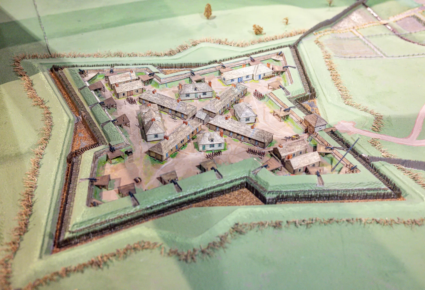 Model of a star-shaped fort with green ramparts on a light green landscape.