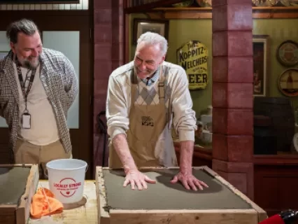 Mickey Redmond casting hands in cement