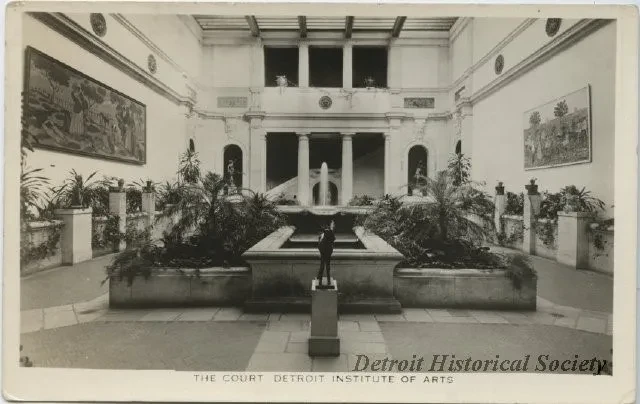 Ornate indoor courtyard with sculptures and plants, monochrome tone, titled "Detroit Historical Society."